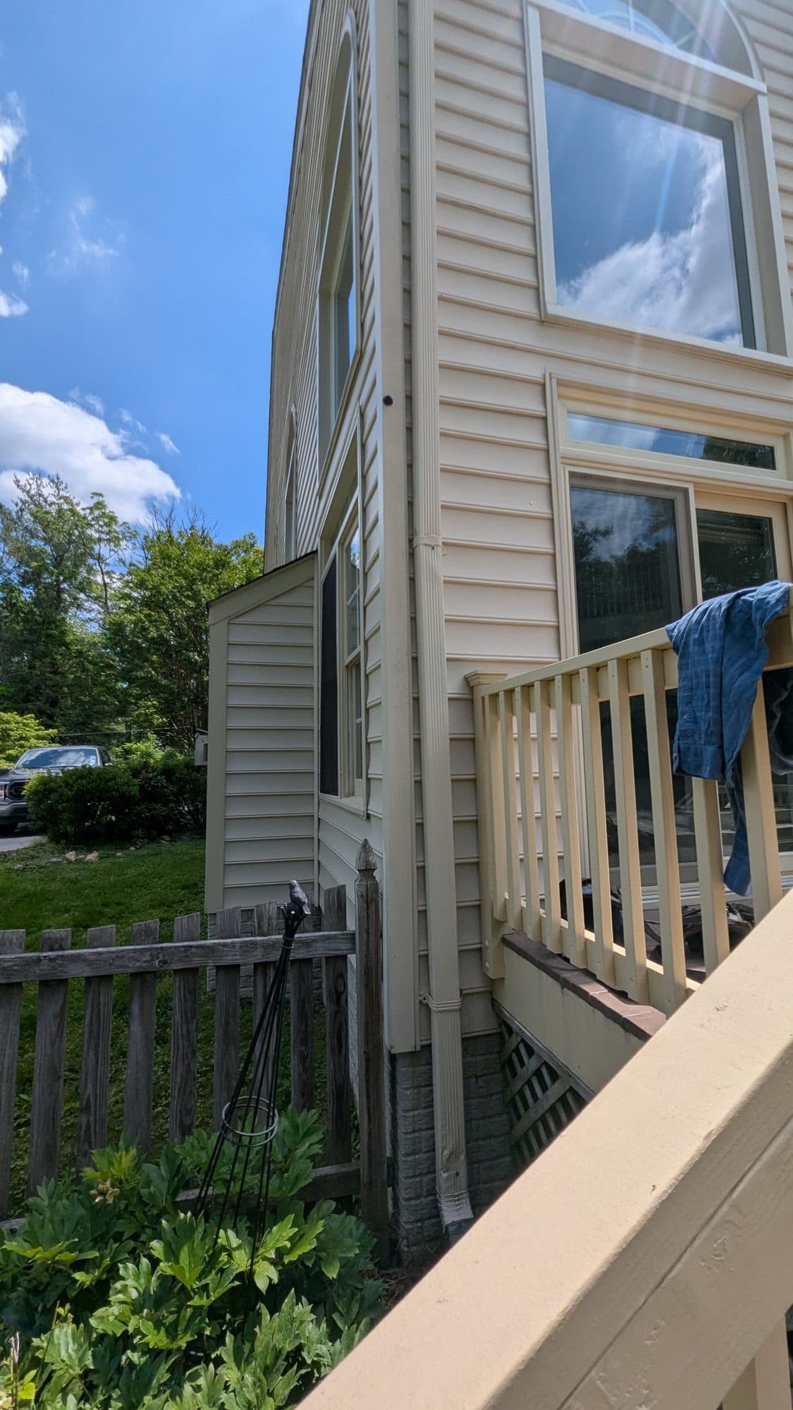 Side of a home with vinyl siding and a deck, part of the same Oakton flat roof repair project