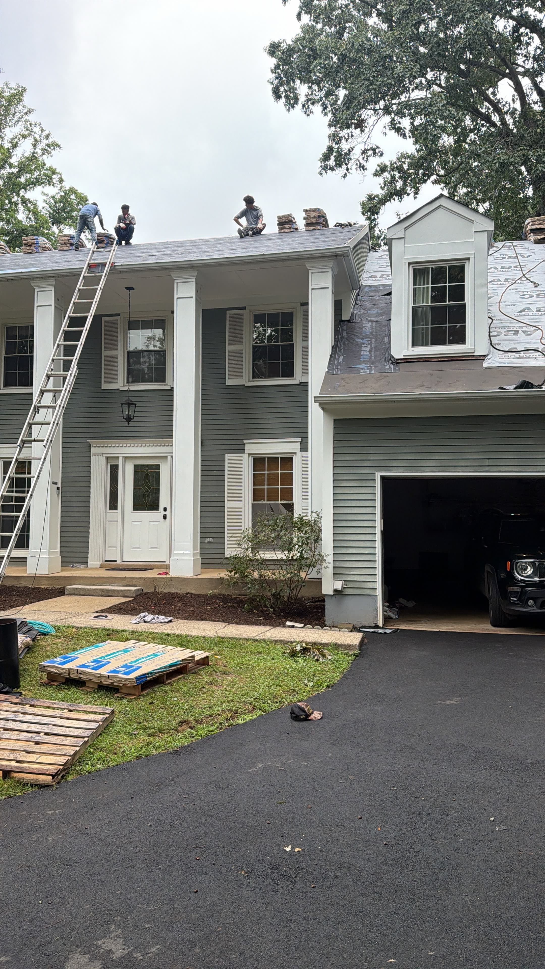 New underlayment installed with shingle bundles staged for installation
