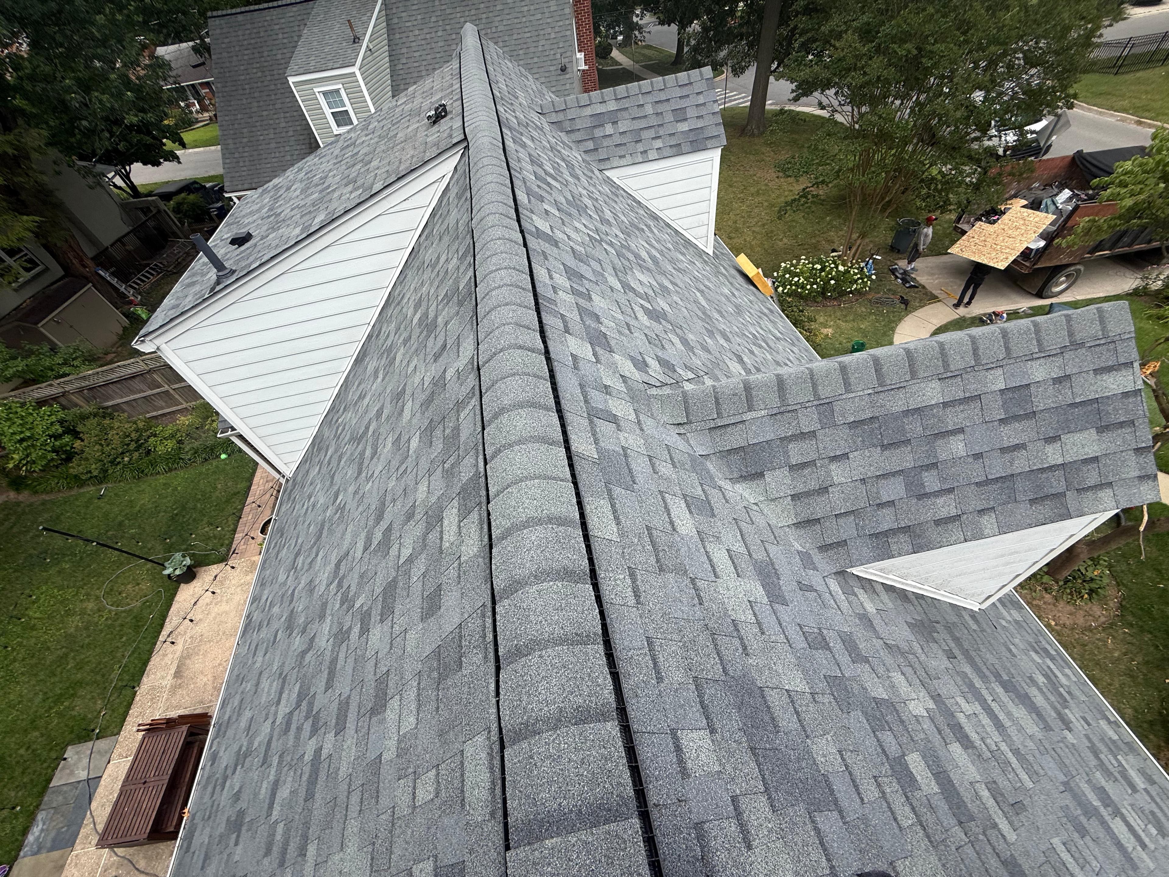 Aerial view of a finished multi-gable roof with new architectural shingles