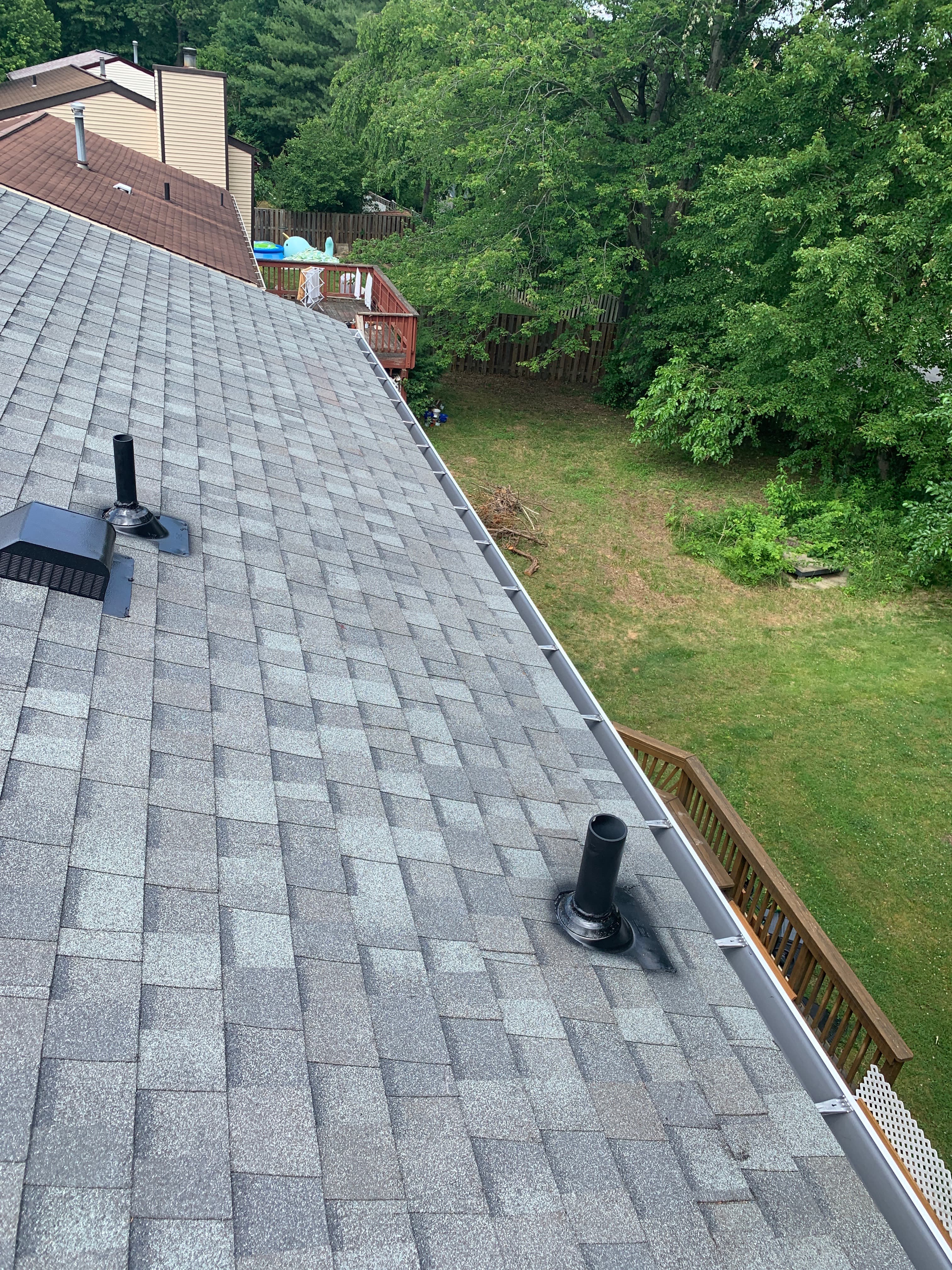 Aerial view of a finished gray architectural shingle roof after a full replacement in Herndon