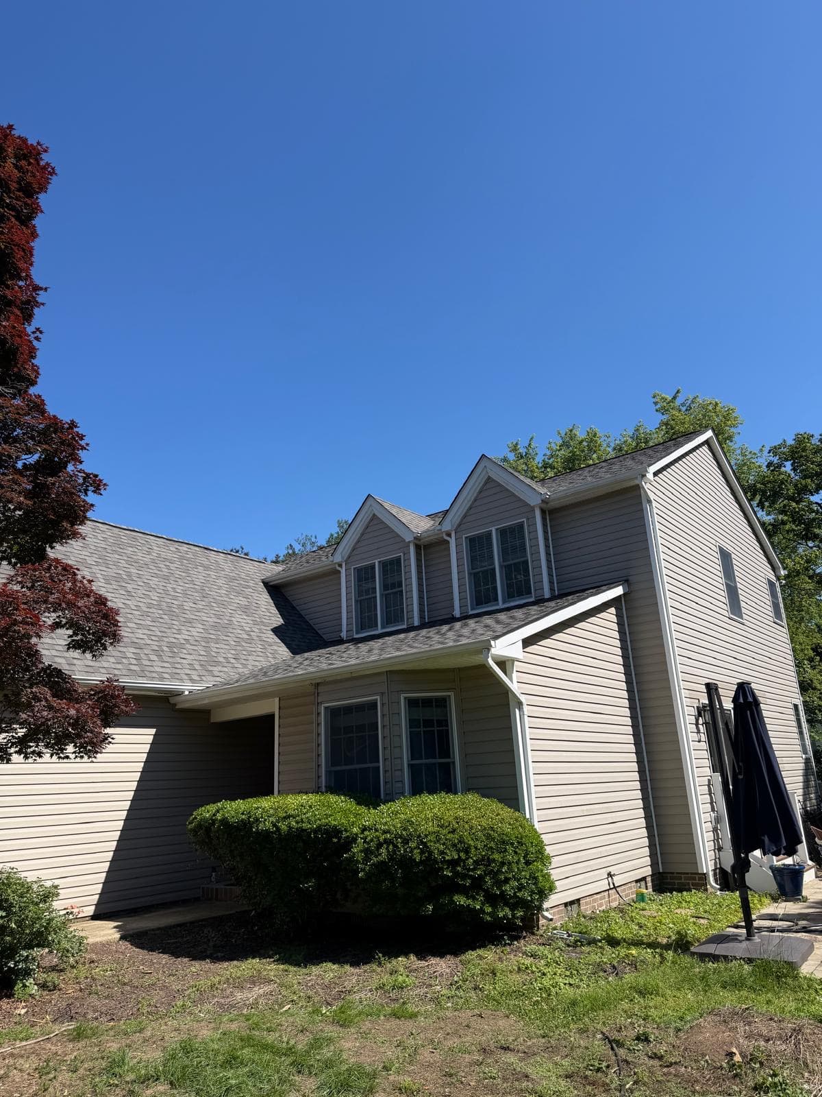 Finished multi-gable roof with new architectural shingles on a two-story home